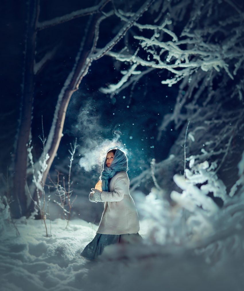 Девочка с фонариком в зимнем заснеженном лесу. Волшебная фотография